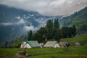 some tents during the day in a valley
